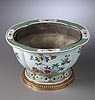 A very beautiful Louis XVI gilt bronze mounted Qianlong famille-rose porcelain jardinière